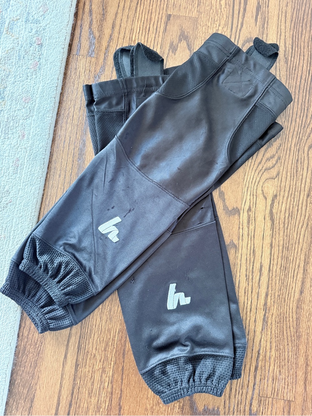 2 pairs of solid black hockey socks, 24 inches long.